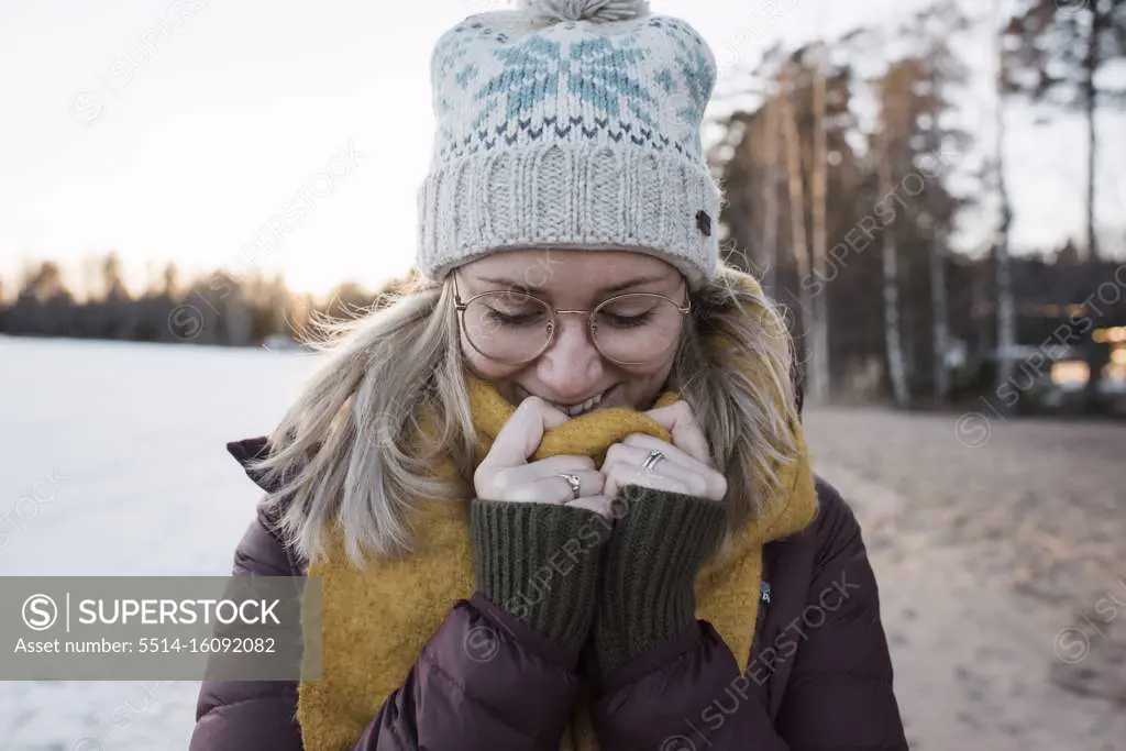 portrait of a woman wrapped up warm whilst at the beach in Sweden