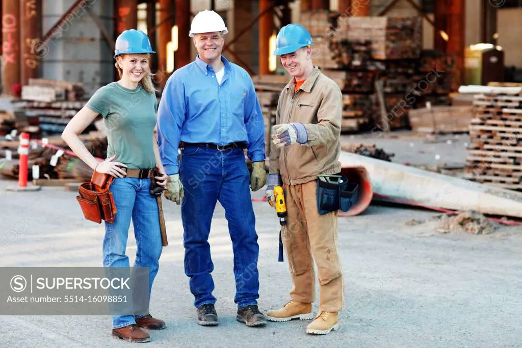 group of construction workers looking at camera on construction site