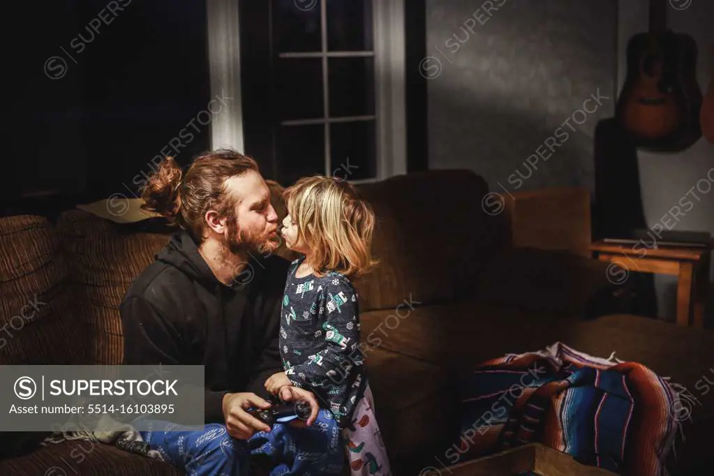 Little boy kissing his dad goodnight