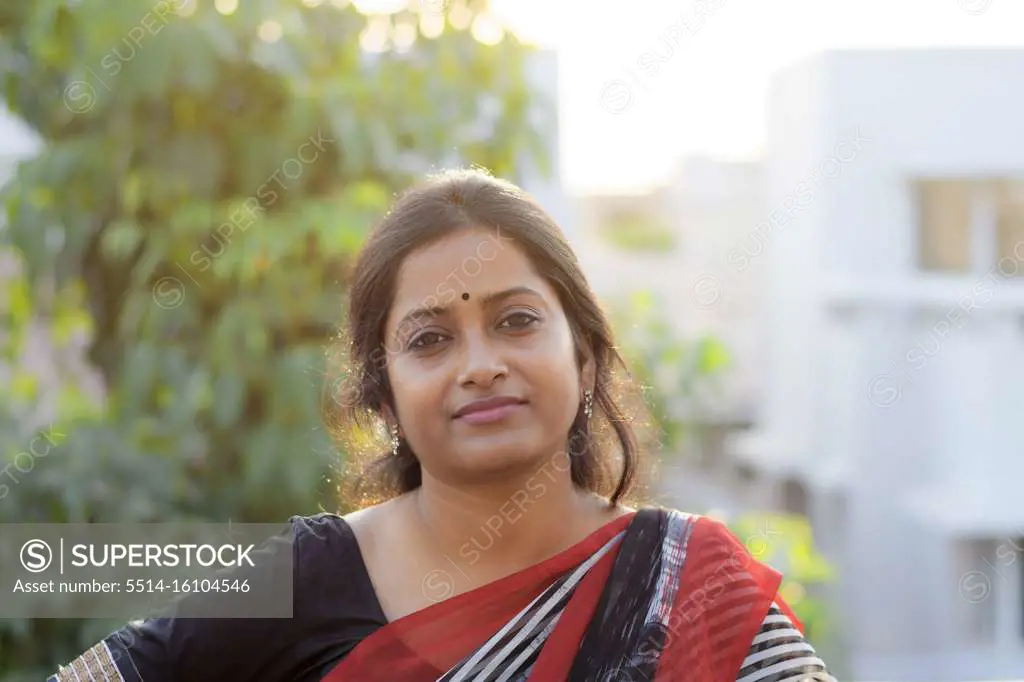 Portrait of an Indian brunette woman on rooftop at sunset time