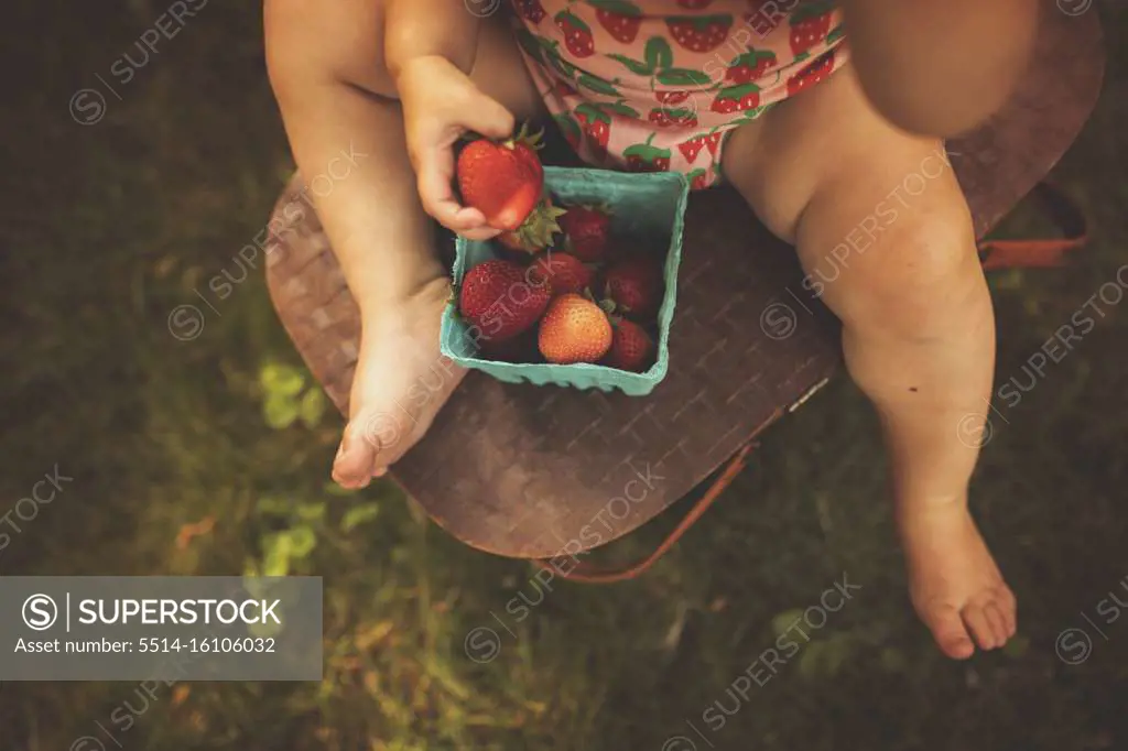 Girl eating strawberries in summer