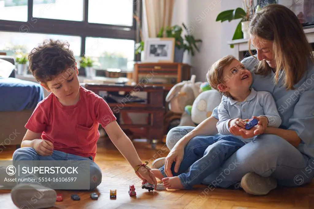 LOVING MOMENT OF HAPPY MOTHER PLAYING WITH HER CHILDREN