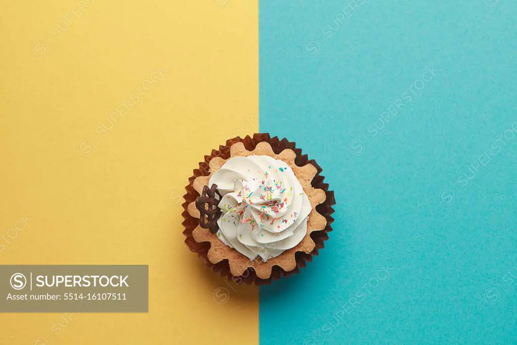 Cupcake on blue and yellow background