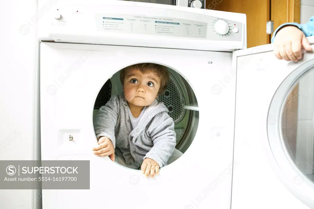 little kid playing with the dry machine