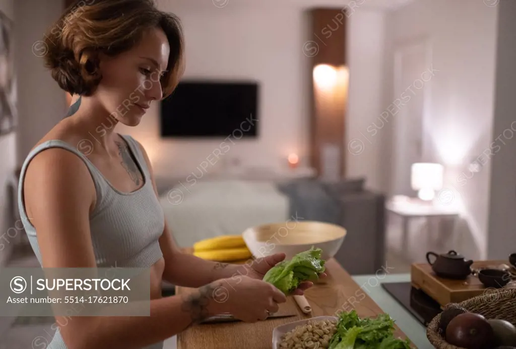 Young woman cooking healthy meal