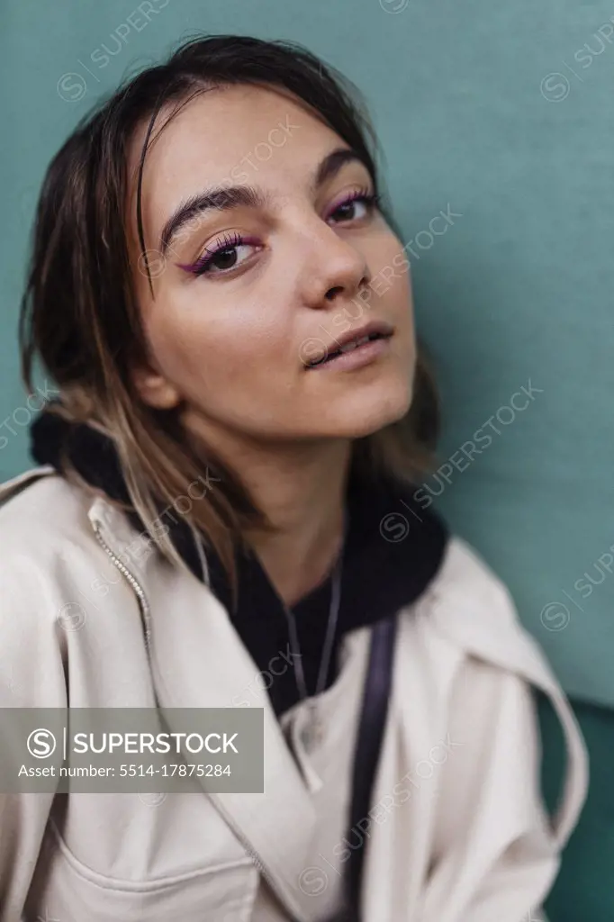 street portrait of a woman on a green background