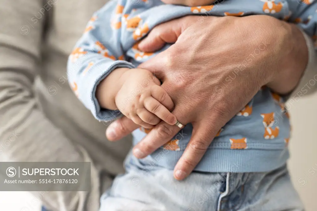 a dad holds his child in his arms