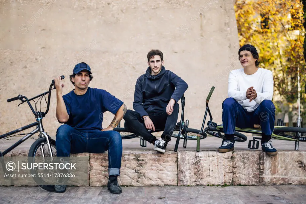 Three men posing with their bmx bikes in the city of Madrid Spain