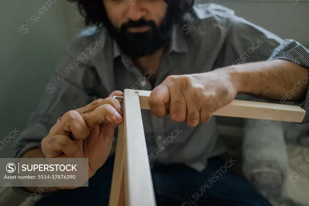 Dad building dollhouse with tools close up of hands