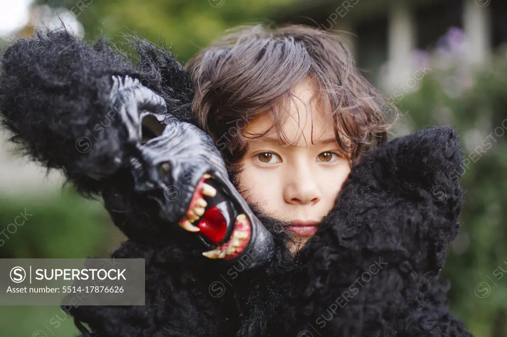 close-up of beautiful boy wearing a gorilla costume outside