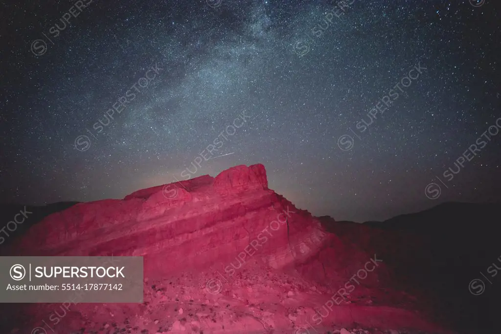 Glowing mountain under starry sky