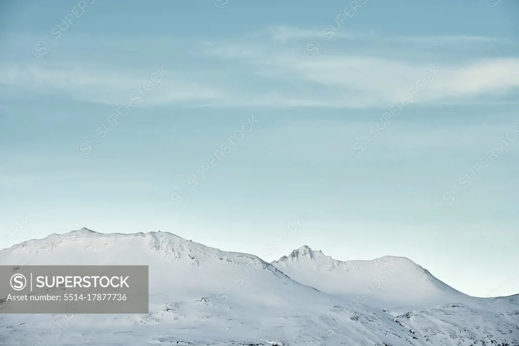 Snowy mountains against blue sky