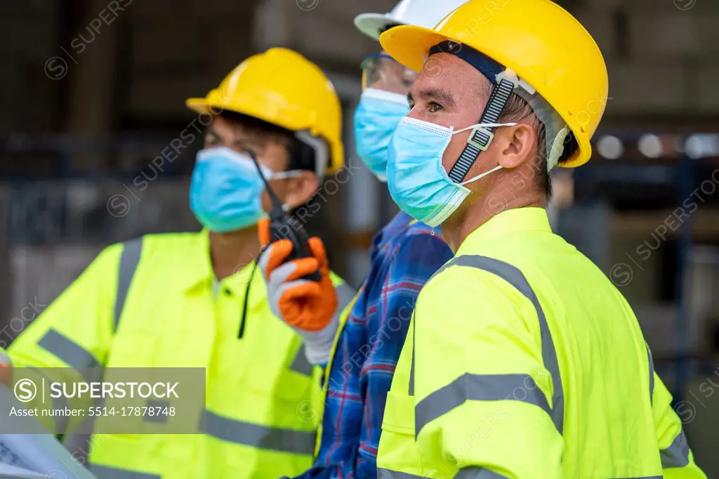 Group civil engineer wearing protective face mask during the ins