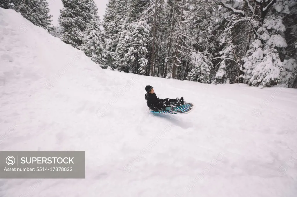 Young Boy Sledding Quickly Down a Hill.