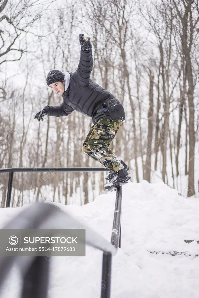 Friends snowskating during winter in forest