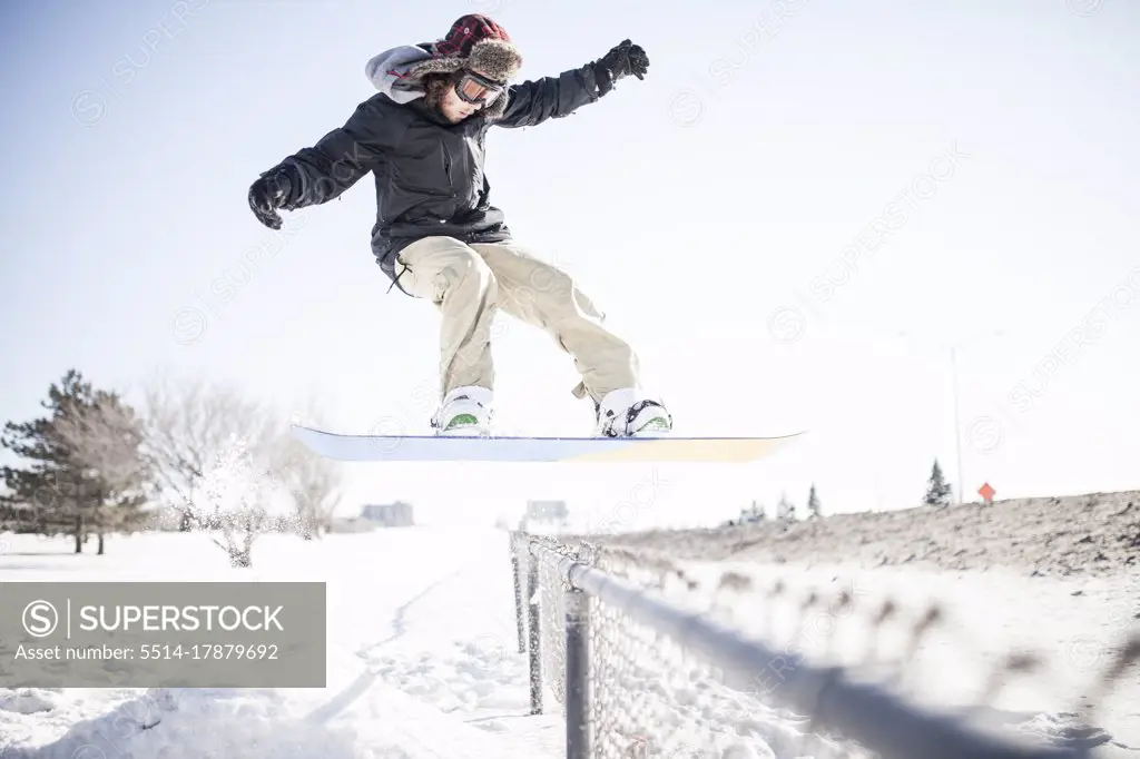 Young snowboarder performing a stunt in mid air