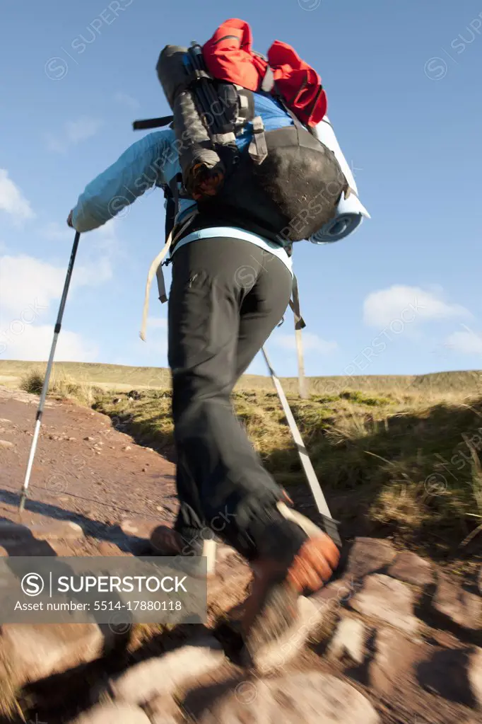 female hiker walking up towards Pen Y Fan in Wales