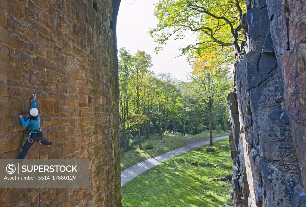 woman climbing up on man made viaduct in Sheffield