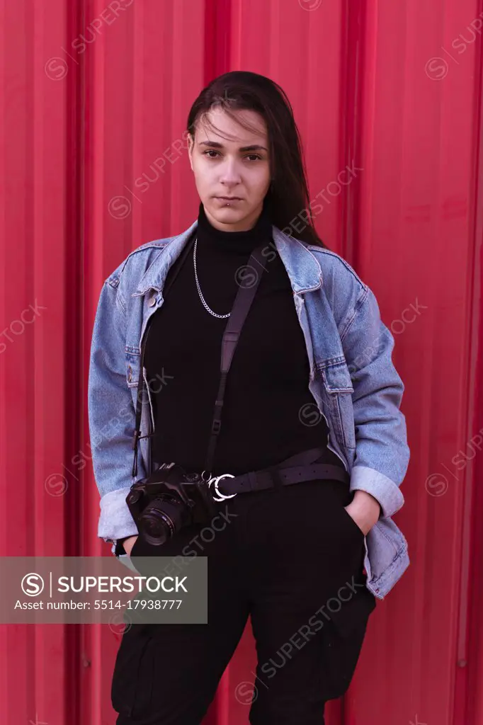 Young girl dressed in modern clothes pictured with her photo cam