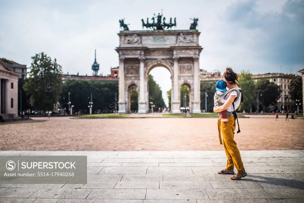 Mother carrying her baby visiting Milan