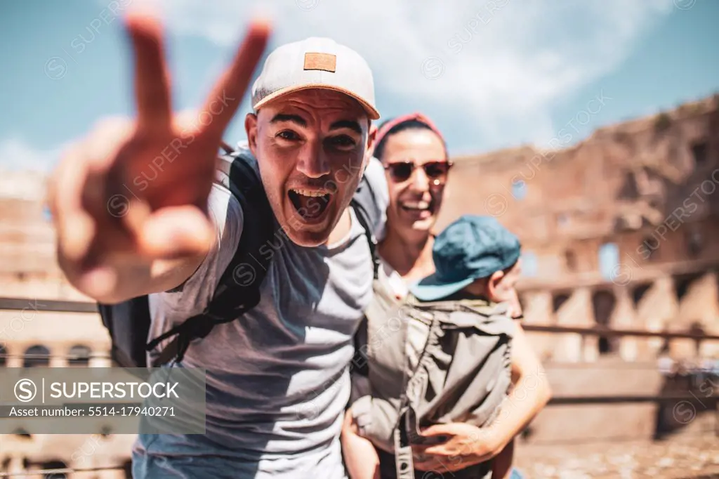 Happy family with baby in the roman Coliseum