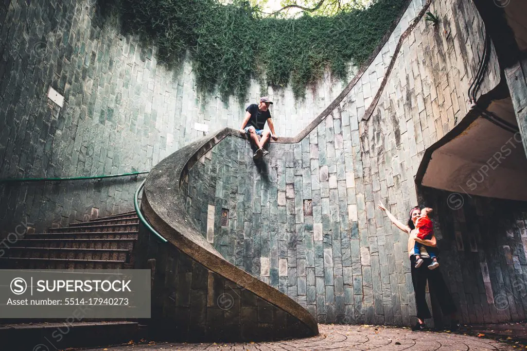 Happy family with baby in some modern stairs in Singapore