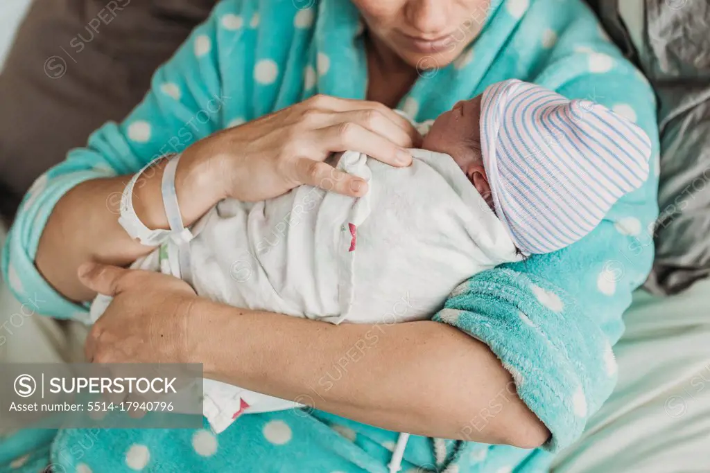 Close up image of mother holding newborn son right after birth