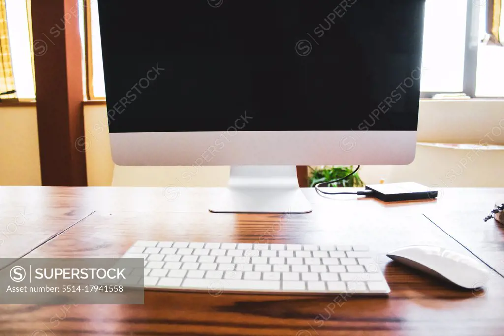 desktop computer on wooden table