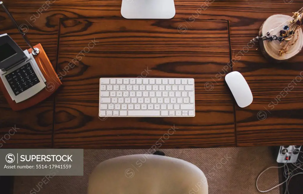 shot of table computer with mouse and keyboard on wooden table