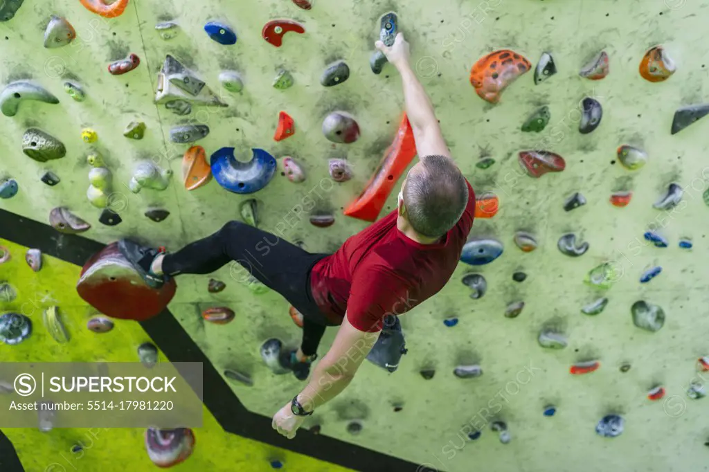 boy training climbing in the climbing wall