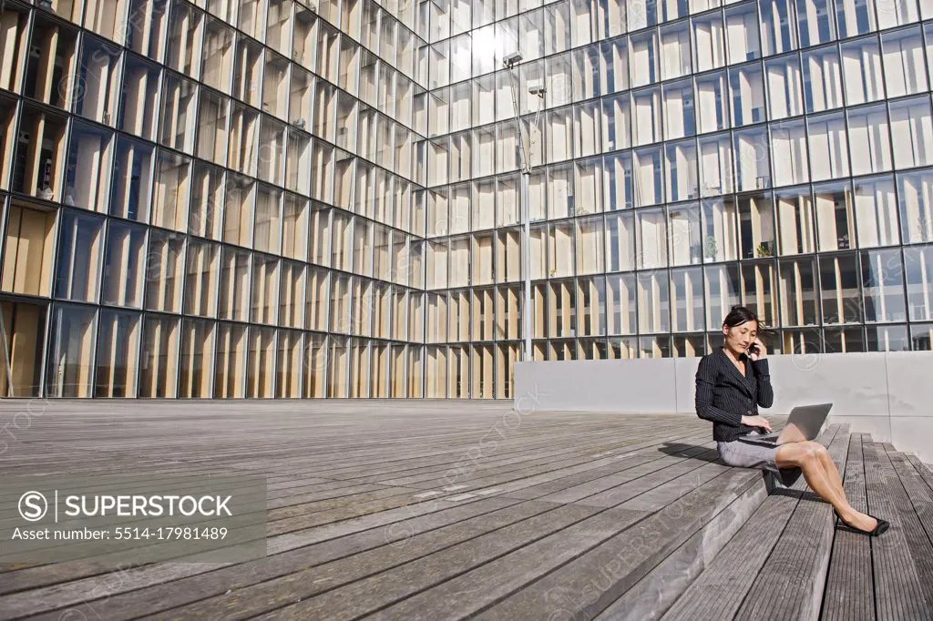 Business woman in Paris working on a laptop