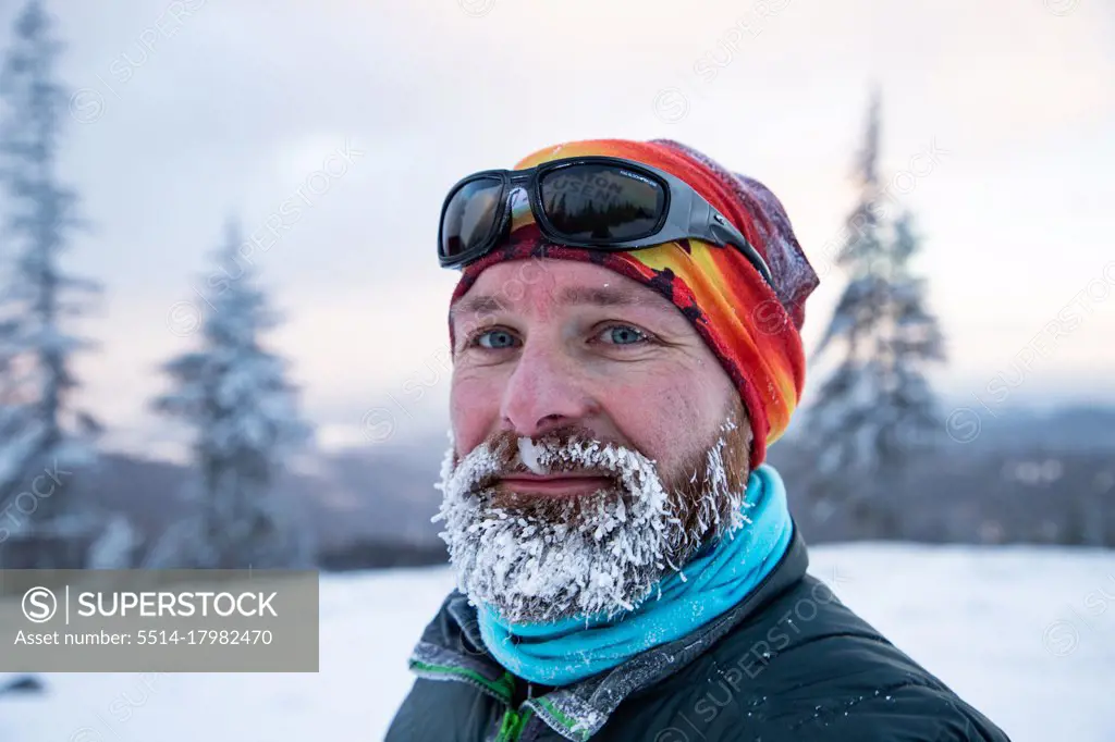 man in extreme weather in winter mountains