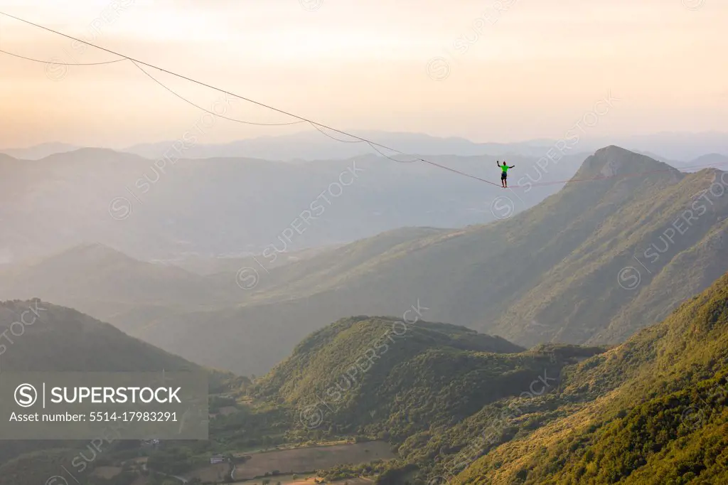 Slackliner standing on the line looking at the landscape