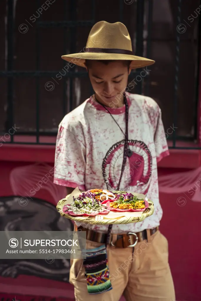 Young mixed race alternative traveller with pink Burritto in Mexico