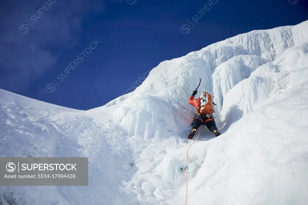 Male Ice climbing guide leading an ice climb in New Hampshire