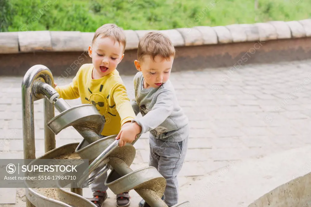 Twin brothers explore the metal construction of the Archimedes screw