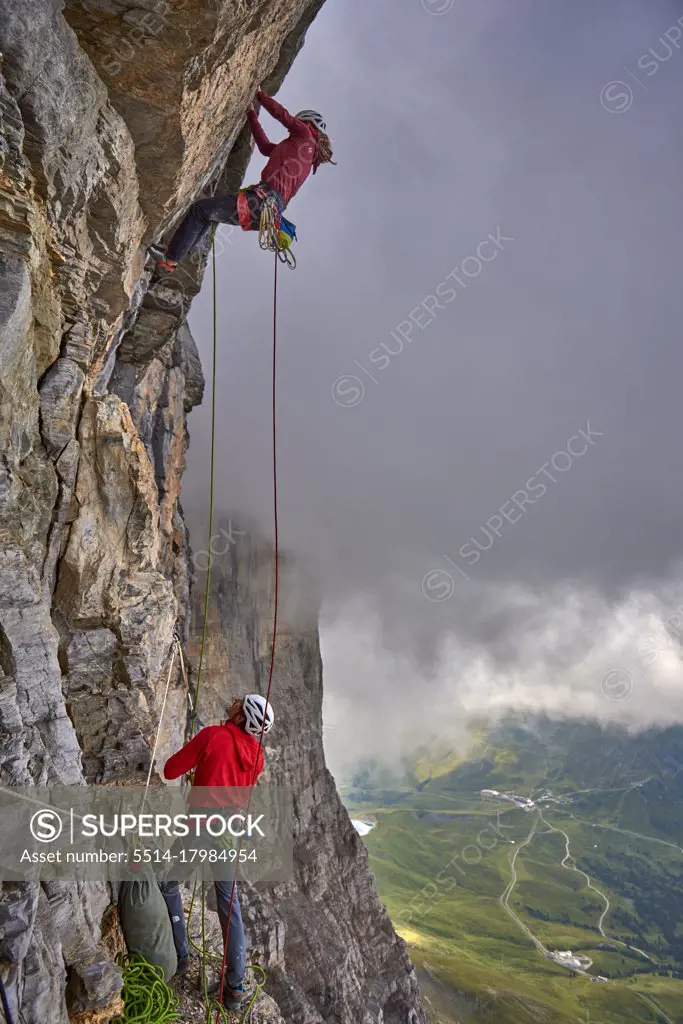 Woman on a difficult rock climb called Odyssee on the Eiger North Face