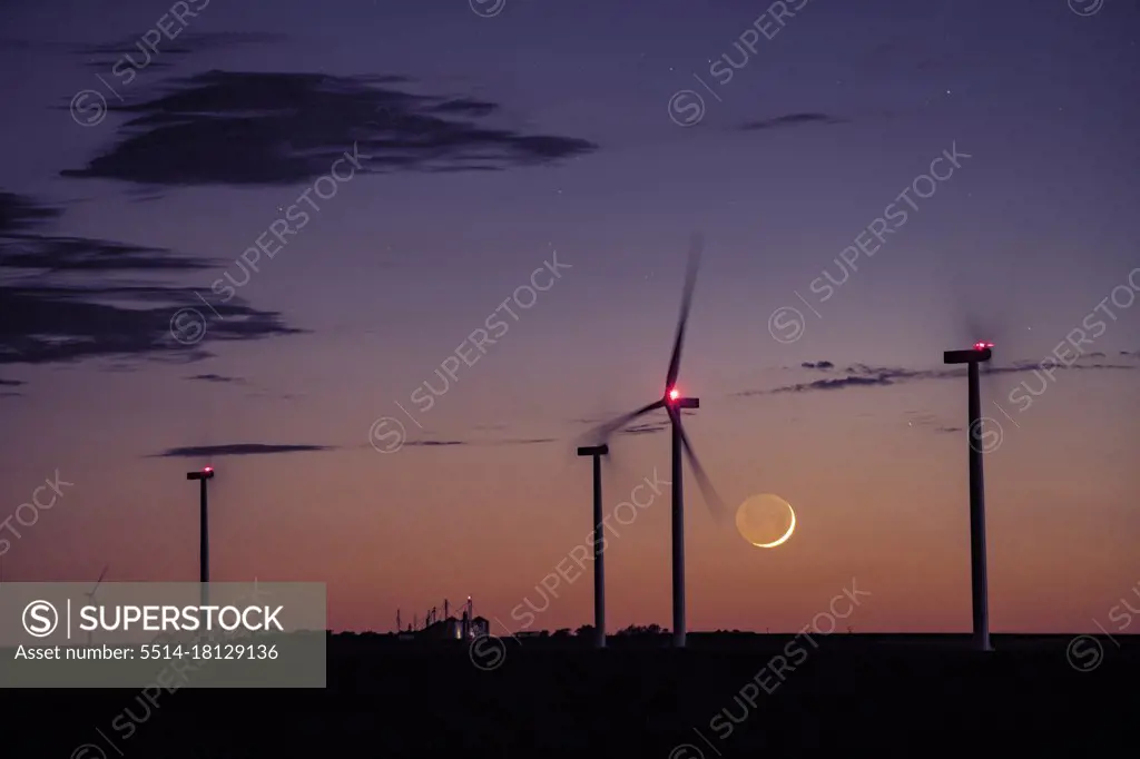 Cresecent Moon Sets Behind Wind Turbines