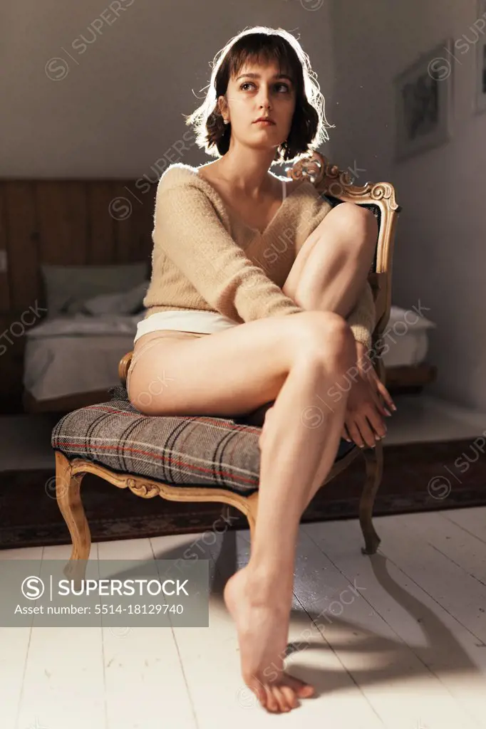 Beautiful Cute Girl Sitting In Underwear On White Sofa Stock Photo