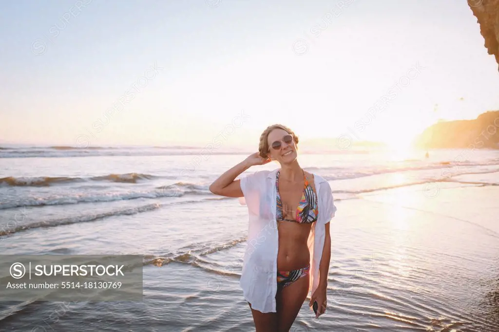 Woman in Tropical  Bikini on the Beach at Sunset