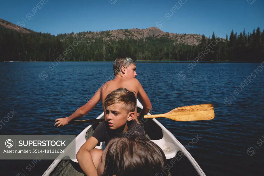 Three Boys Head out on a journey in a small Canoe