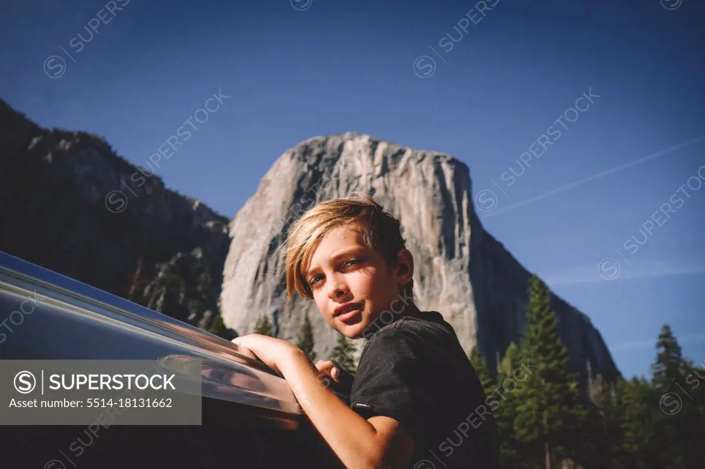 Blonde Boy Hangs from Car window with El Cap in the Background