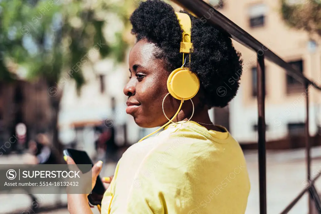 Rear view of a black girl with afro hair and hoop earrings