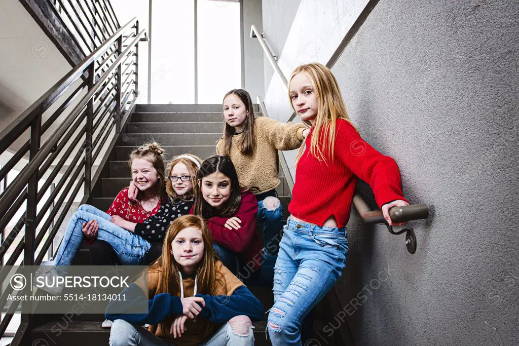 Group of 6 cute Tween girls hanging out having fun in the city.