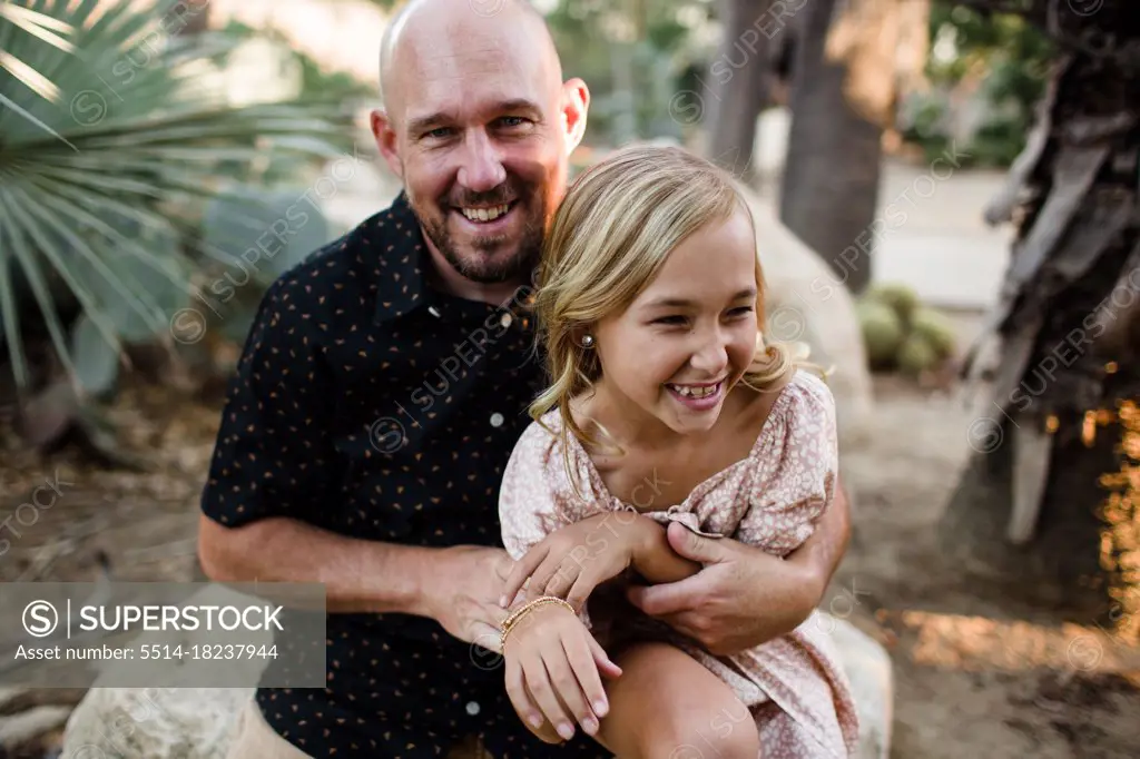 Dad Tickling Daughter in Garden in San Diego