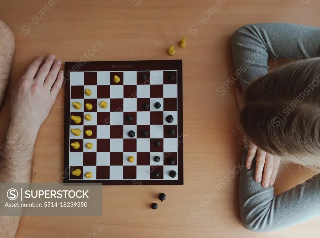 two players are thinking while playing chess top view