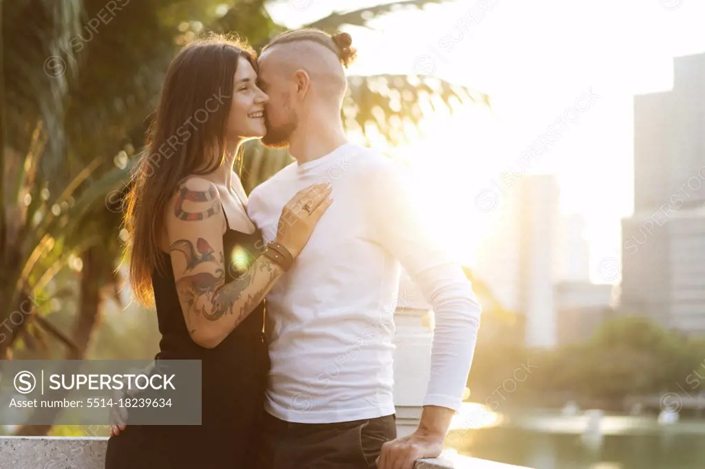 couple in love at sunset in the sunshine in tropical metropolis