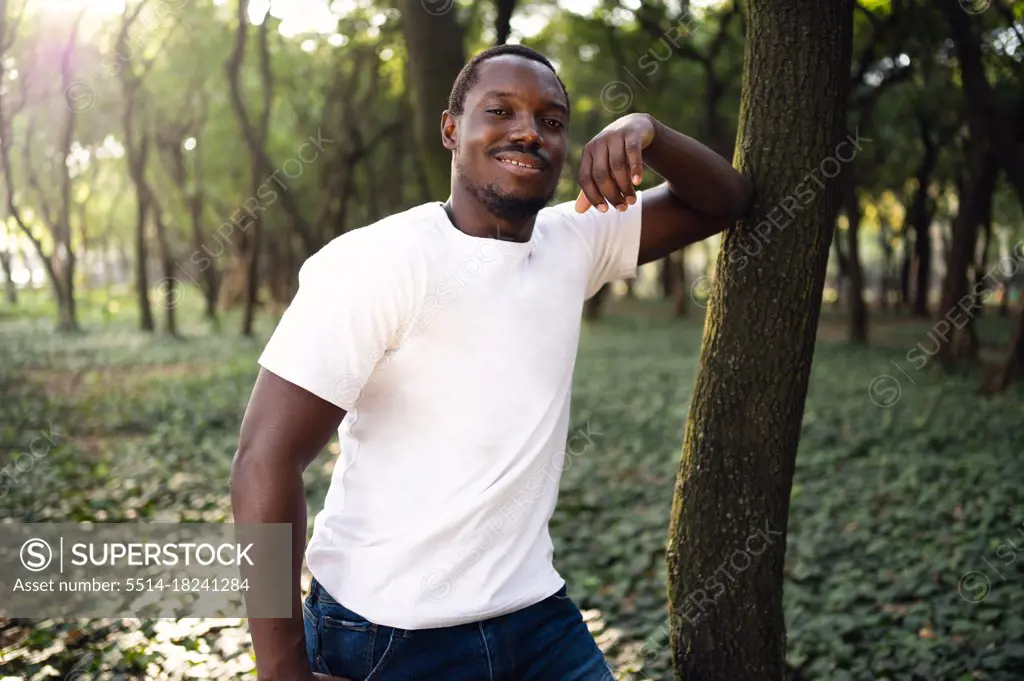 A young black man in park. Outdoor portrait of traveler. Portrait