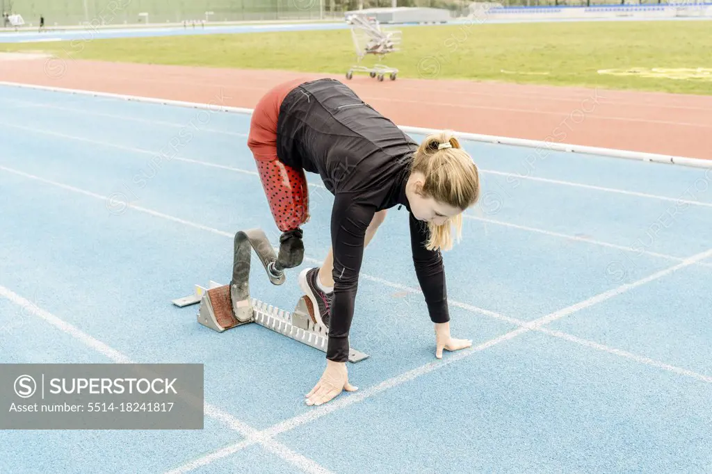 Side view of female athlete with prosthetic leg