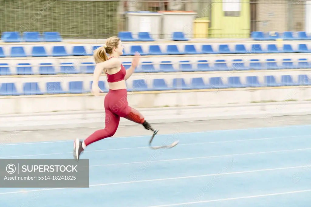 Female athlete with prosthetic leg running